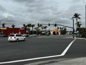 A minivan runs a red light at the Anaheim Intersection of Harbor Blvd. and Ball Rd., which is a common mistake that sets the stage for Anaheim car accidents.