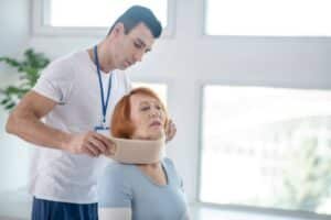 A woman getting medical attention after an accident, an example of a person who should contact a personal injury attorney in Orange County to get compensation for their injuries and distress.