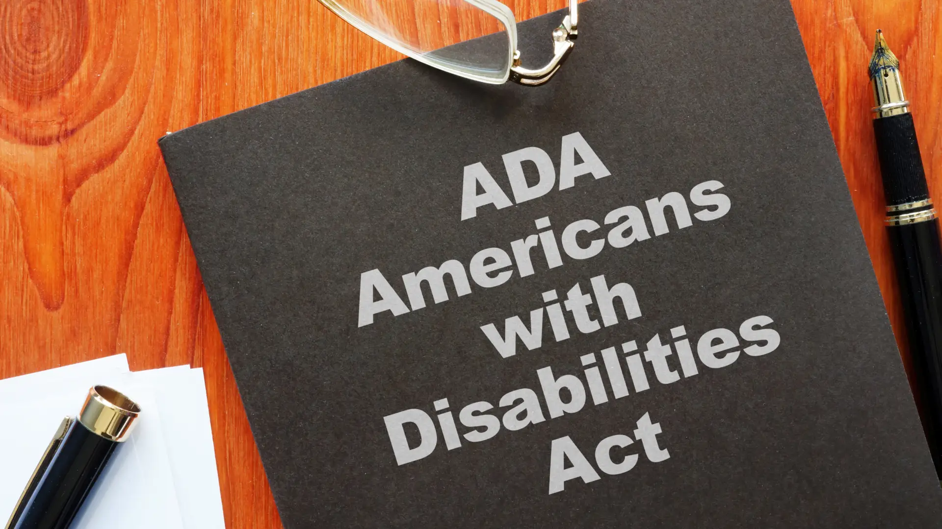 Close-up of a folder labeled “ADA Americans with Disabilities Act” – representing website accessibility compliance